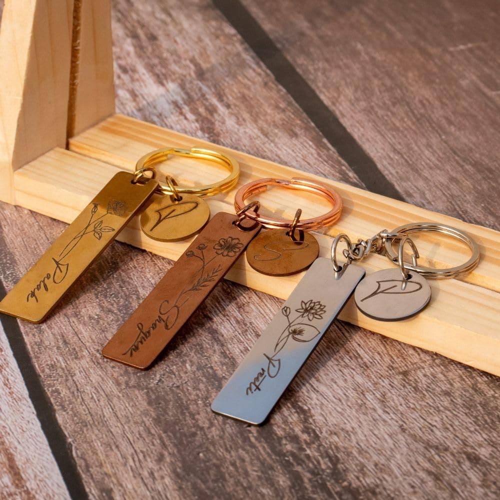 WEHATKE Personalised Birth Flower Metal Keychain with Custom Name and Initial Charm, Stainless Steel Engraved Keyring in Gold, Silver and Bronze, Unique Gift for Couples, Friends and Loved Ones